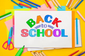 Back to school background. Top view flat lay concept. Childish lettering, colored paper, supplies, stationery for primary school, elementary school or grade school