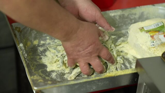 the cook dredges the fish in flour for frying