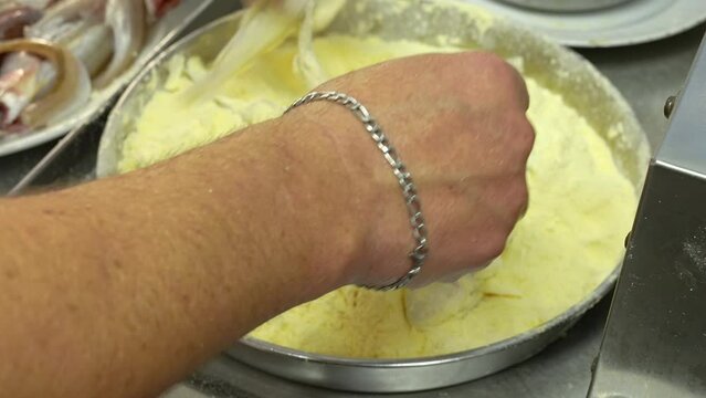 fish is flouring for frying