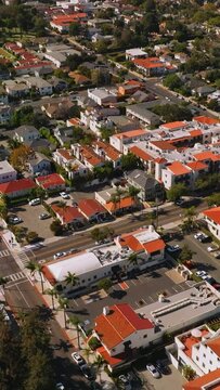Lovely sight of Santa Barbara houses with similar orange roofs. Beautiful streets of sunny city from aerial perspective. Vertical video