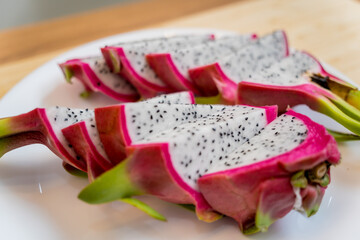 Chef cuts and peels dragon fruit on the cutting board