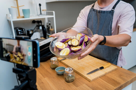 The chef is broadcasting live from workshop how to prepare a grilled eggplants with garlic
