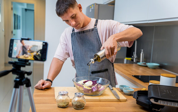 The chef is broadcasting live from workshop how to prepare a grilled eggplants with garlic