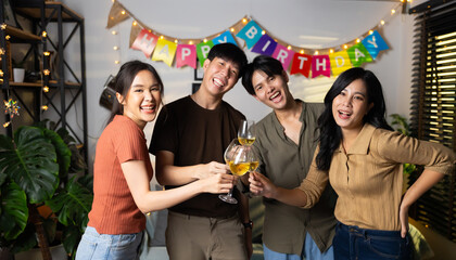 Group of young asian people smiling friends drinking at birthday party toast with beer. food and beverag