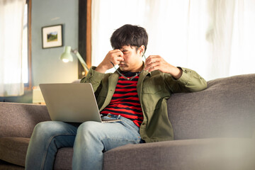 Fototapeta premium sad depression serious people from work,study stress problem.asian man feeling tired suffering using computer working work place.concept global economic,health problems