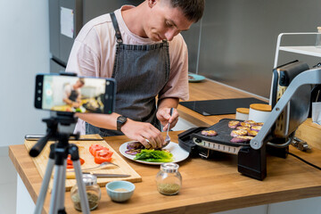 The chef is broadcasting live from workshop how to prepare a grilled eggplants with garlic