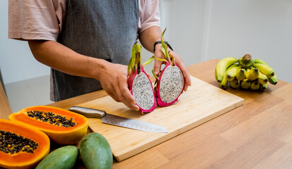 Chef cuts and peels dragon fruit on the cutting board