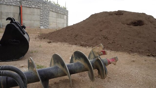 Drill. Drilling the earth using a drilling machine. . Drilling to install a fence. Drilling tool. Earth drill for planting shrubs and trees.