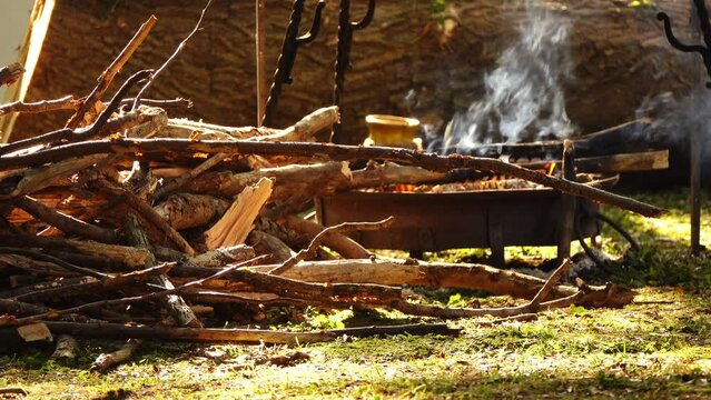 Small metal focus for cooking over open fire. Prepared by forest brushwood to incite fire.
