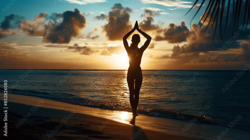 Sticker silhouette of a person practicing yoga on the beach at sunset.