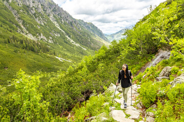 beautiful girl hiking in the Polish mountains during the summer day