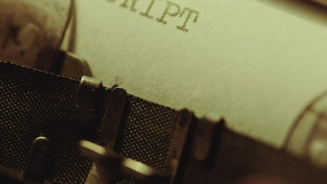 Printing Script as title in upper case and then Part One on next line on paper page with typewriter. Extreme close-up shot