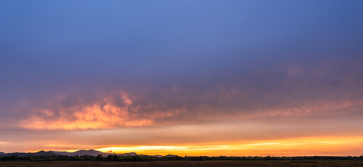 sunset sky over hill countryside in the evening