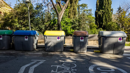 Row of colorful recycling bins in an urban park setting, symbolizing environmental conservation, suitable for sustainability and World Environment Day concepts