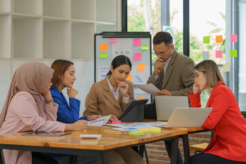 Group of business people having a meeting in a tech company. Creative business professionals planning a project in an office. Teamwork and collaboration in a modern workplace.