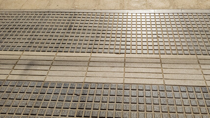 Urban tactile paving with textured ground surface indicators for the visually impaired,...