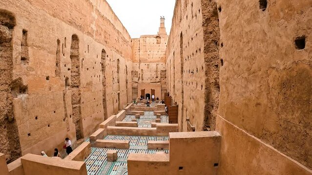 A group of tourists wandering inside El Badi Palace in Marrakesh, Morocco - June 1, 2024