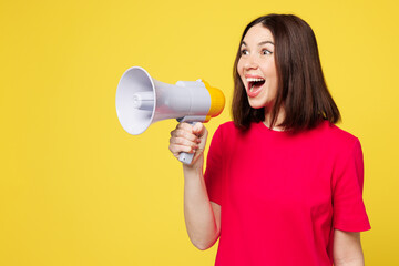 Young surprised woman she wear pink t-shirt casual clothes hold in hand megaphone scream announces discounts sale Hurry up isolated on plain yellow orange background studio portrait Lifestyle concept