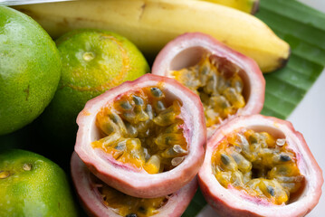 Extreme Closeup of Oranges Bananas and Passion Fruits Served in Plate. Tropical Fruits Concept