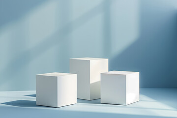 Three white cubes podiums on a pastel blue background, for product display mock up