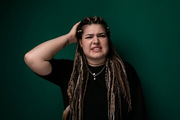 Woman With Dreadlocks Standing in Front of Green Wall