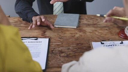 Lawyers are discussing legal terms at a contract signing meeting. Lawyers are negotiating an agreement to mediate the parties' dispute.