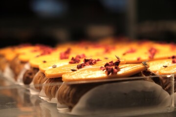 A display case of eclairs. Showcase with desserts.