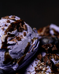 Purple ice cream scoops are studded with chocolate chips. Macro photo.