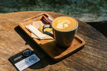 cup of cappuccino, a cup of coffee and a biscuit, a cup of coffee on a wooden table, a cup of...