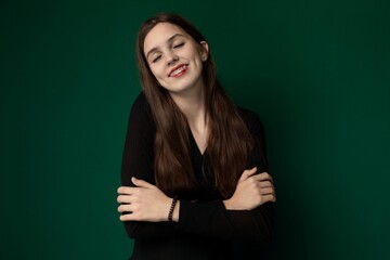 Woman With Arms Crossed in Front of Green Background