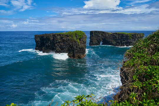 Black volcanic cliffs with big waves at O Le Pupu Pue lava fields in Samoa