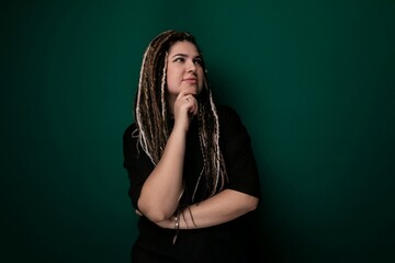 Woman With Dreadlocks Standing in Front of Green Wall