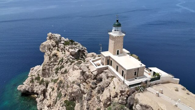 Aerial drone photo of beautiful and picturesque cape Melagavi forming a small peninsula with unique lighthouse stand out next to archaeological site of Heraion, Loutraki, Greece