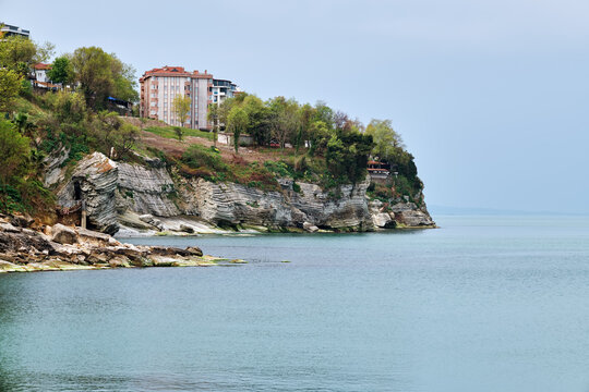 Buildings and houses on a rocky promontory or cliff rocks in Akcakoca, Turkey.