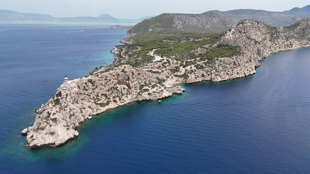 Aerial drone photo of beautiful and picturesque cape Melagavi forming a small peninsula with unique lighthouse stand out next to archaeological site of Heraion, Loutraki, Greece