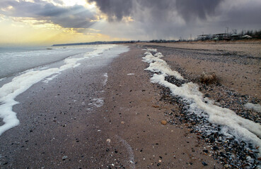 Black Sea coast, dirty foam along the coast, sea pollution, environmental problem, Ukraine.