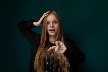 Woman With Long Red Hair Pointing at the Camera