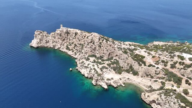 Aerial drone photo of beautiful and picturesque cape Melagavi forming a small peninsula with unique lighthouse stand out next to archaeological site of Heraion, Loutraki, Greece