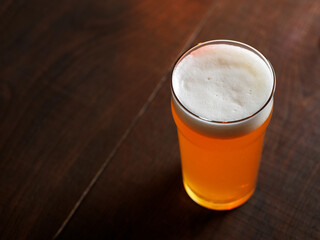 Beer glass on a wooden table with copy space