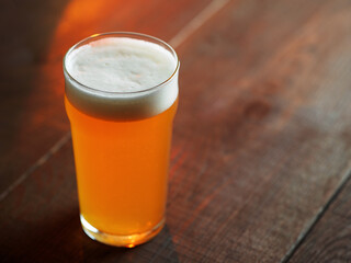 Beer glass on a wooden table with copy space