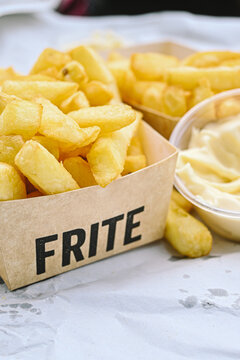 Belgian Frites - Fries - Chips in a tray with fritessaus (mayo)