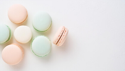 Obraz premium Delicious pastel macarons on table. French dessert. Sweet and tasty food. Top view.