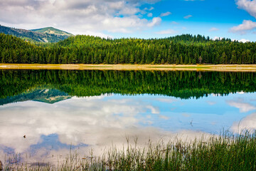 Reflection in smooth water of mountain lakes