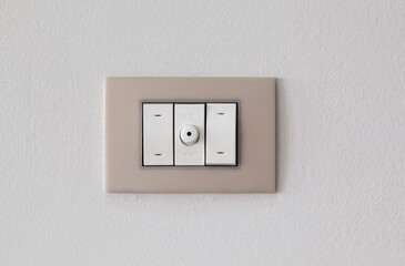 European style wall light switch on a white background. Three sections and dimmer control. Space for copying