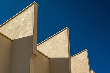 Triangular shadows on corner of apartment wall. Geometric style