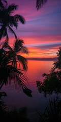 A tropical sunset scene with palm trees against a purple twilight sky reflected in the ocean.