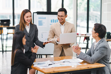 Professional diverse business team presenting and discussing data charts and graphs during meeting in modern office.