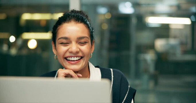 Laptop, project management and winner with business woman in office at night for research.Computer, celebration and success with happy professional employee in creative workplace for online design