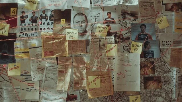 Close-up view of evidence board with clues, mugshots, geographic maps, forensic sketches, newspaper articles, crime scene photos and sticky notes connected with thread in police office