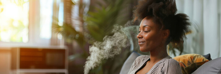 an African American woman using essential oils in a diffuser as part of her morning relaxation routine